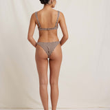 Person wearing a checkered bikini set on a plain background