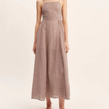 women wearing maxi Dress features a square neckline, elasticated back and free-flowing maxi skirt. It turns to reveal a statement open back with an adjustable tie feature.