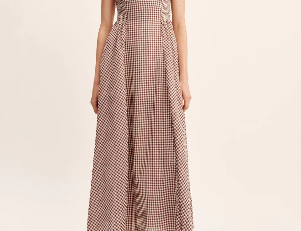 women wearing maxi Dress features a square neckline, elasticated back and free-flowing maxi skirt. It turns to reveal a statement open back with an adjustable tie feature.